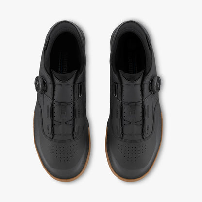 Black shoes with brown soles on a white background
