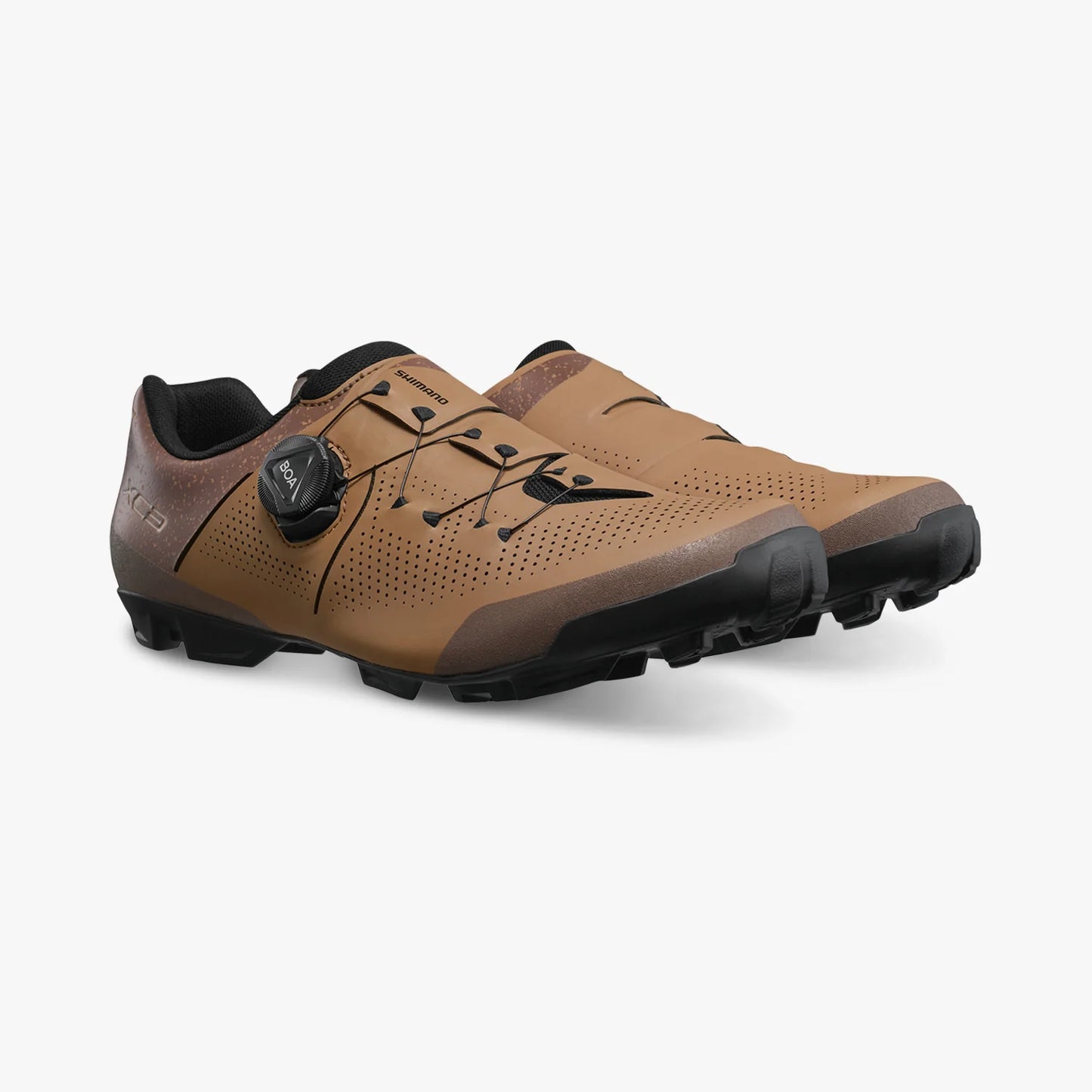 Brown cycling shoes with black accents on a white background