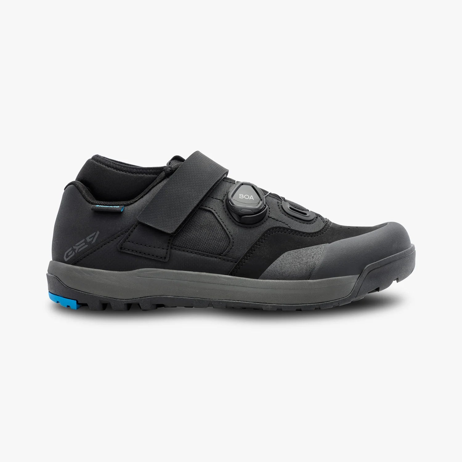 Black athletic shoe with a blue sole on a white background