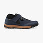 Navy blue shoe with brown sole on a white background