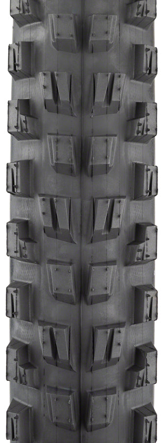 Close-up of a tire tread pattern with prominent knobs on a black background