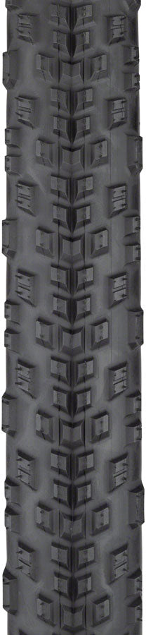 Tire tread pattern with prominent tread blocks on a black background