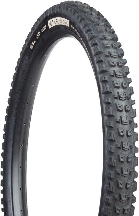 Black off-road tire with tread pattern on a white background
