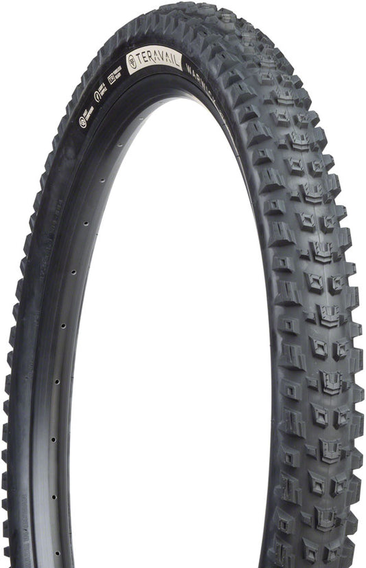 Black off-road tire with tread pattern on a white background