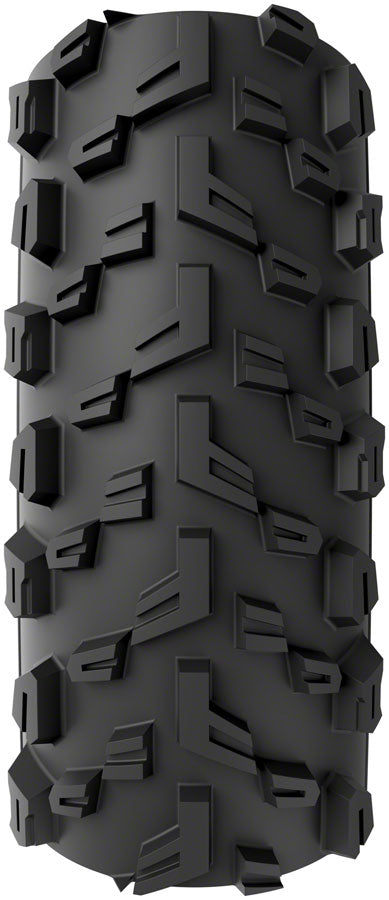 Close-up of a black off-road tire with prominent tread pattern