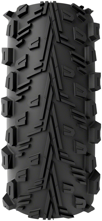 Black off-road tire with prominent tread pattern on a white background