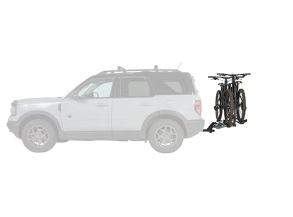 White SUV with a bike rack attached, carrying a bicycle on a white background