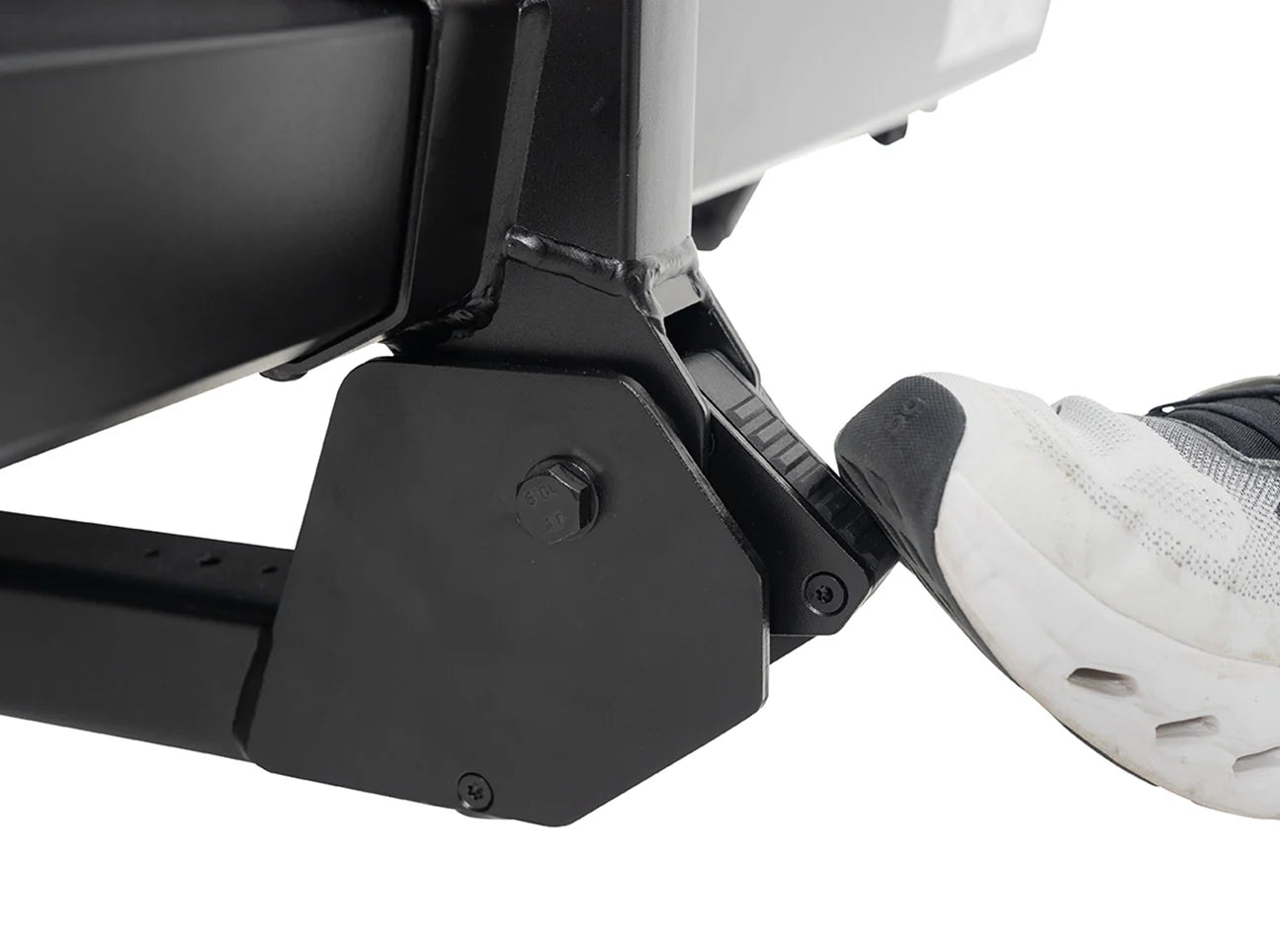 Close-up of a black metal footrest on a white background