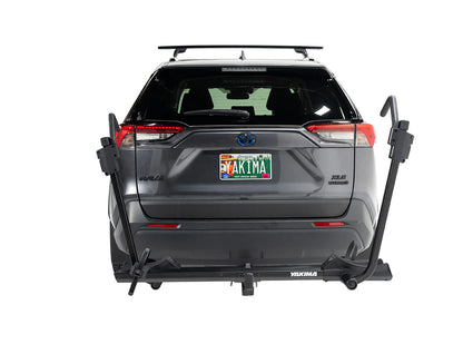Gray SUV with a bike rack attached on a white background