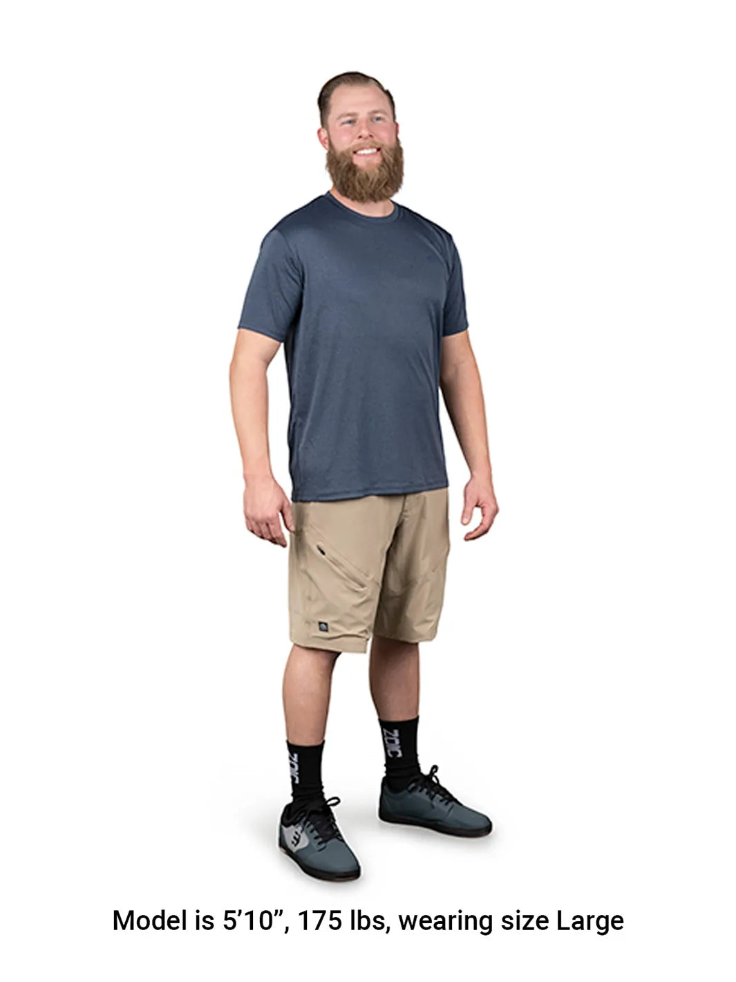 Man wearing a blue t-shirt and beige shorts on a white background